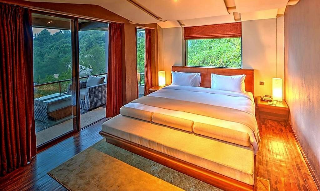 A cosy bedroom with warm lights and huge  windows  | Kavya Resort and Spa, Nagarkot