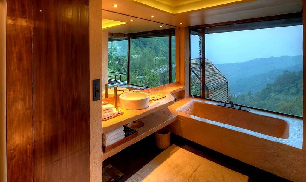 An outdoor view bathroom with a tub and mirror above the sink | Kavya Resort and Spa, Nagarkot