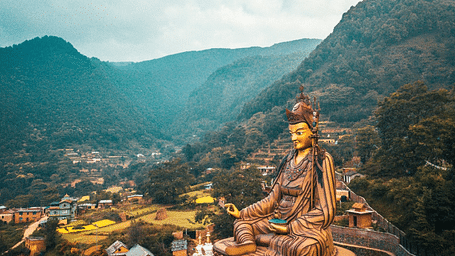 A huge statue of a religious idol surrounded by a few temples | Kavya Resort and Spa, Nagarkot