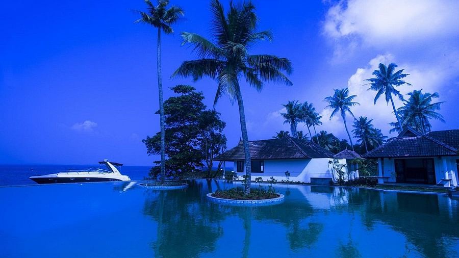 Speedboat idling on water near a resort - Rhythm Kumarakom