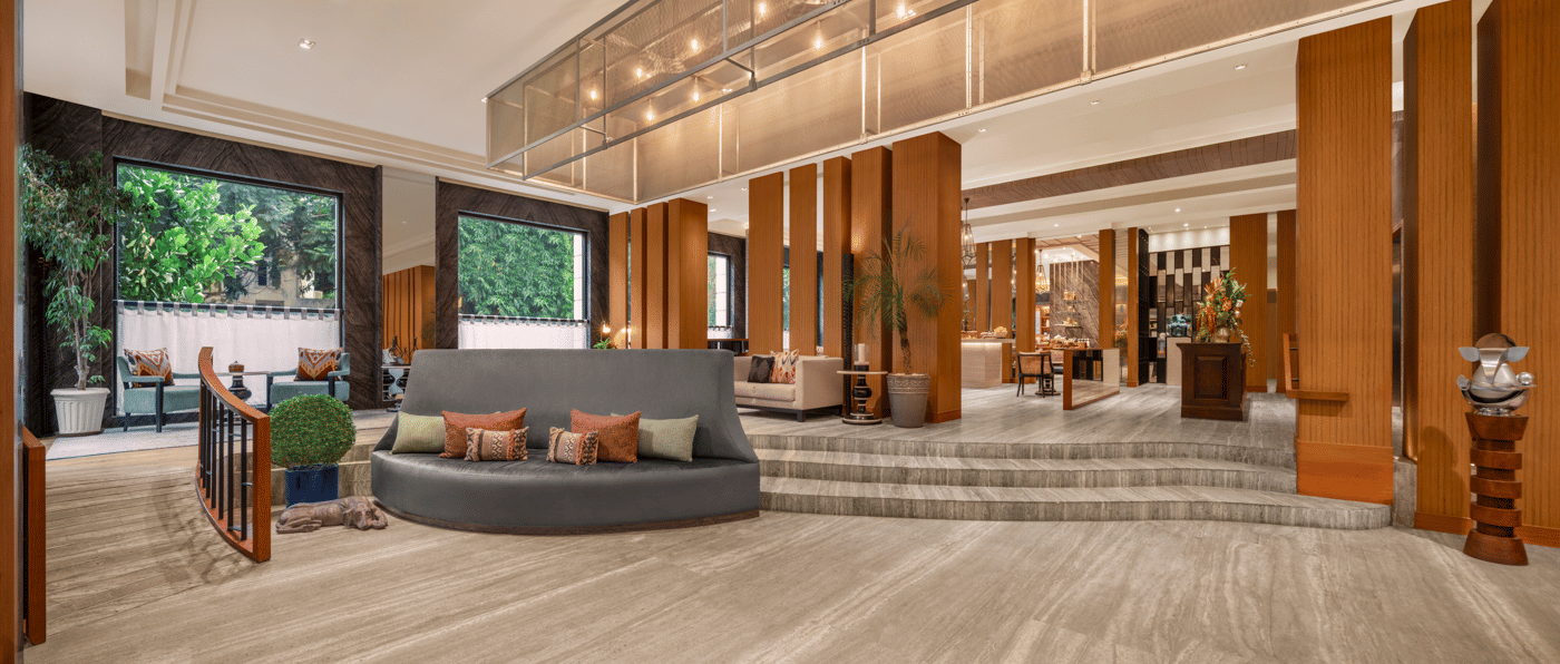 Lobby with seating area, reception desk, and ceiling lights at The Raintree, St. Mary’s Road.