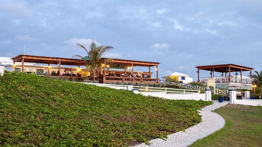 Pathway leading to pavilions on green lawn | Abaco Inn