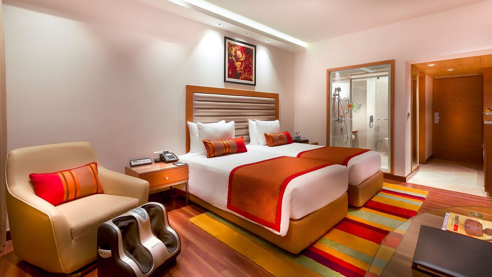 Grand Club Room with twin size beds and sofa chair at Grand Chennai By GRT Hotels.