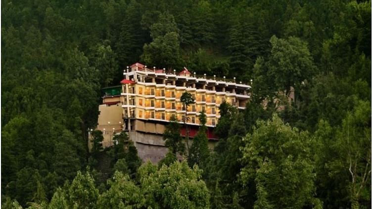 Facade of JK Clarks Exotica in Dalhousie amidst lush greenery