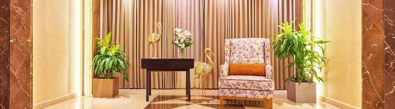 A tale and a sofa kept in the Corridor of Visthara - Urban Boutique Hotel, Bangalore