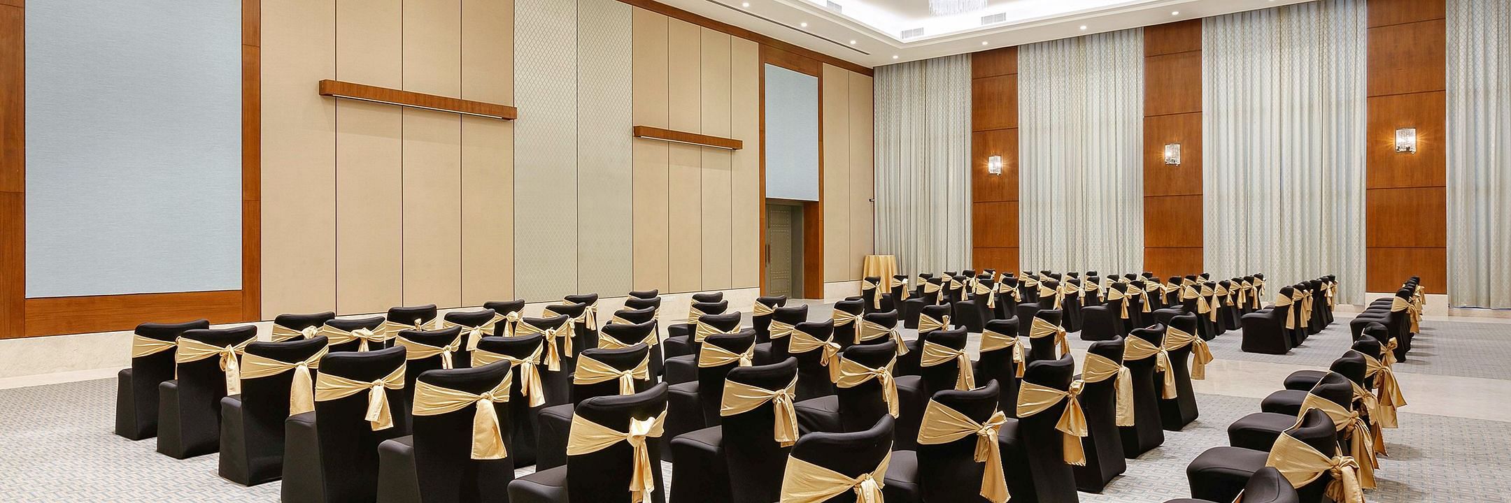 Theatre style seating arrangements inside the a banquet hall at Karma Lakelands set up for an event