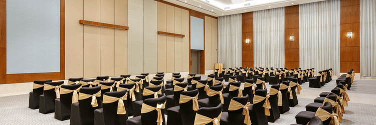 Theatre style seating arrangements inside the a banquet hall at Karma Lakelands set up for an event.