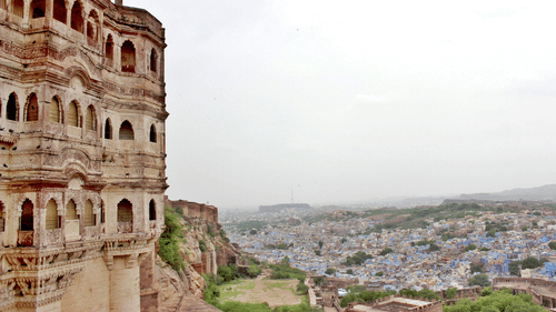 A wide view of the side of a fort with the city in the backdrop