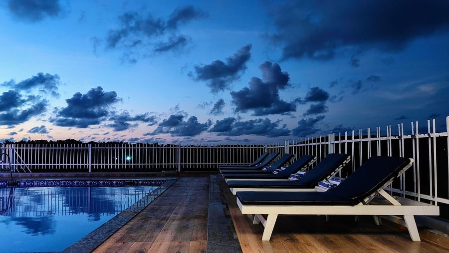 View of rooftop swimming pool during the evening  at Vagator Downtown, Goa