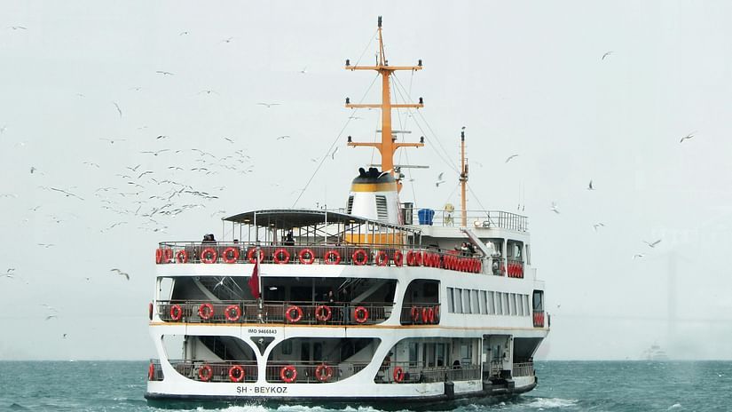 A ferry passing by in ocean. 