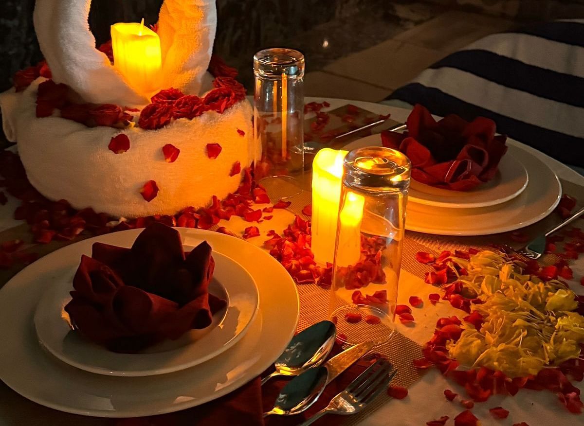 A beautifully set table with a special cake, candles, and romantic decorations for a celebration. - Sea Hills Resort, Swaraj Dweep (Havelock)