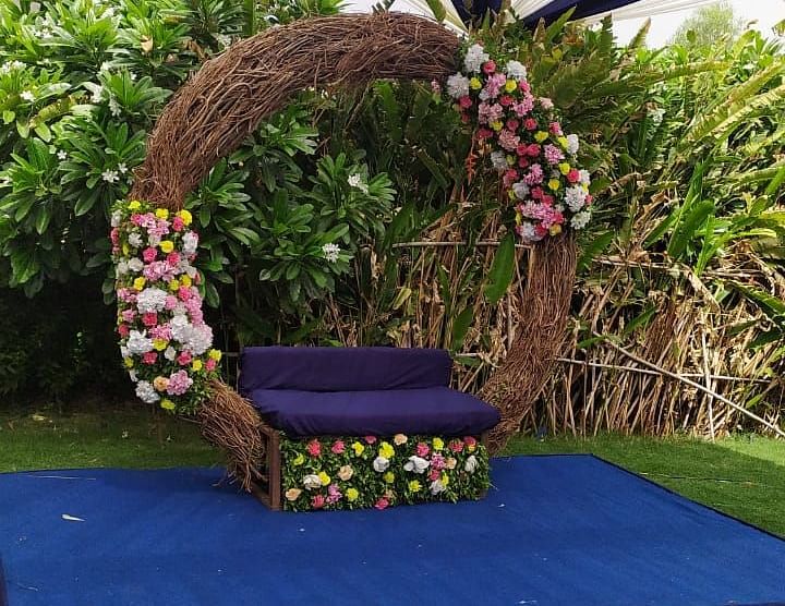 Circular floral swing, fabric, green grass, close up.