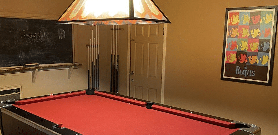 A pool table with a light on top