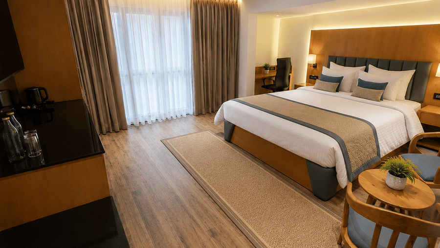 A Premium Room's bedroom with a large bed, wooden flooring, and a window at BluSalzz Collection - Casa Onze, Arpora.