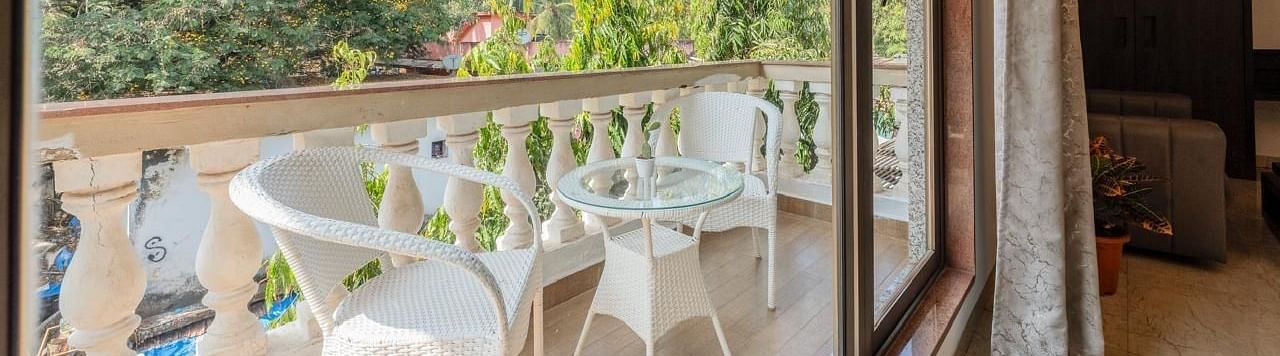 Image of Premium Room Balcony with two chairs and a table at Calux Joia Do Mar Resort, Goa.
