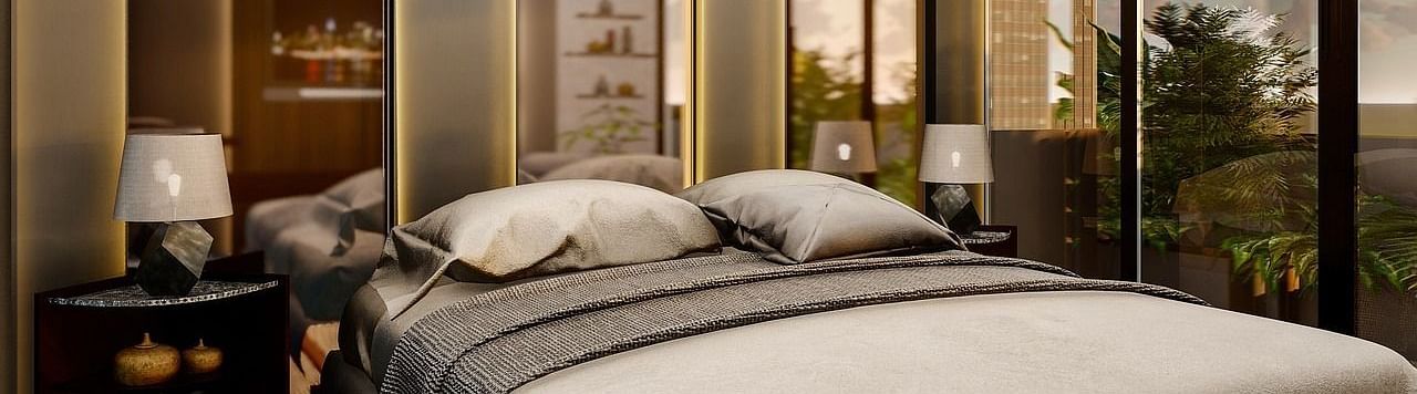 Modern bedroom with a king size bed, mirrored walls, and elegant decor.