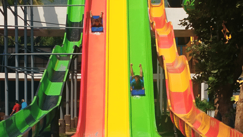 Colourful water slides plunge into the pool at an exciting adventure park in Coimbatore | Black Thunder.