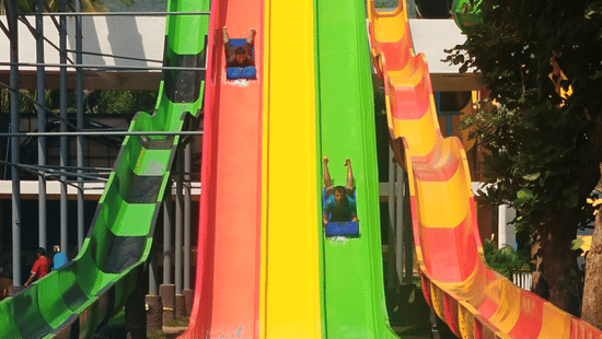 Colourful water slides plunge into the pool at an exciting adventure park in Coimbatore | Black Thunder.