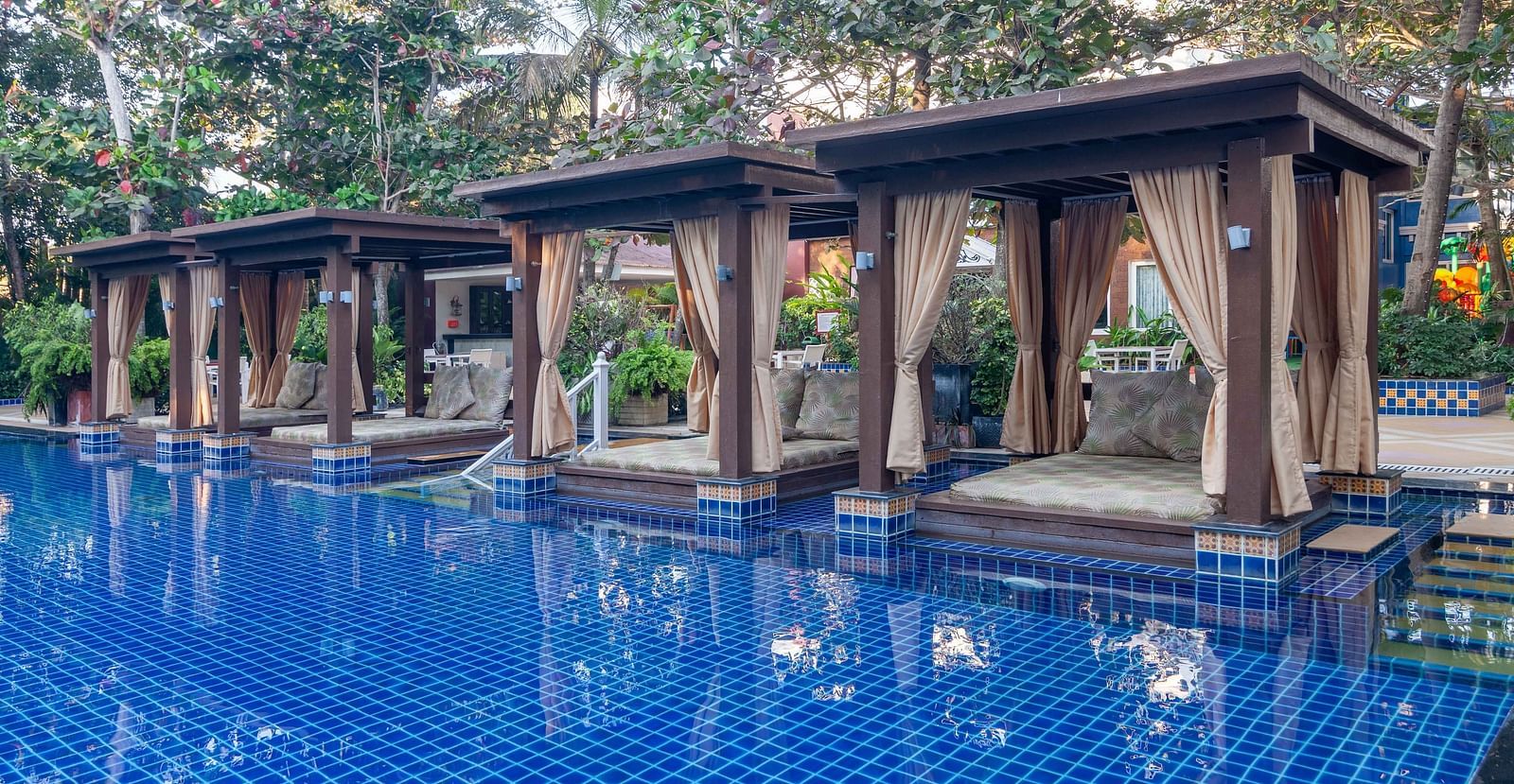 swimming pool along with poolside beds - Mayfair Palm Beach Resort, Gopalpur-on-Sea