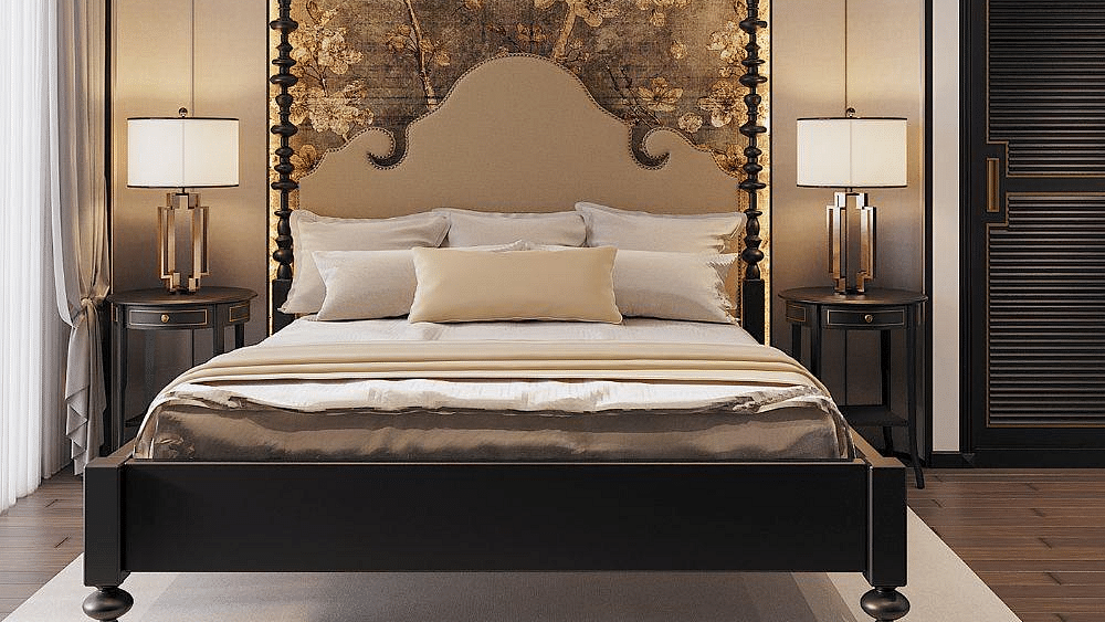 Front view of a well-made bed with cushions, a ceiling fan, and two bedside tables with lamps at The Evren, Vagator.