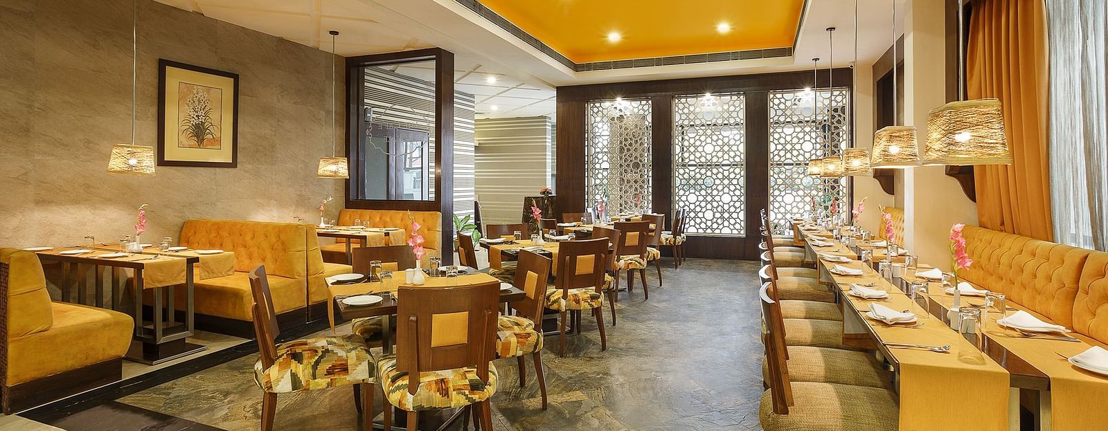 A spacious dining space with wooden chairs and a buffet setup ready to welcome guests for a meal - The Manor, Bareilly