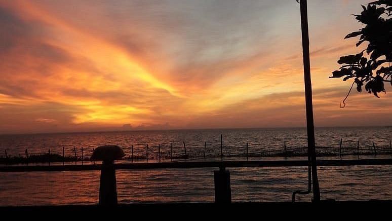 Sunset throwing golden shades on the clouds - Rhythm Kumarakom