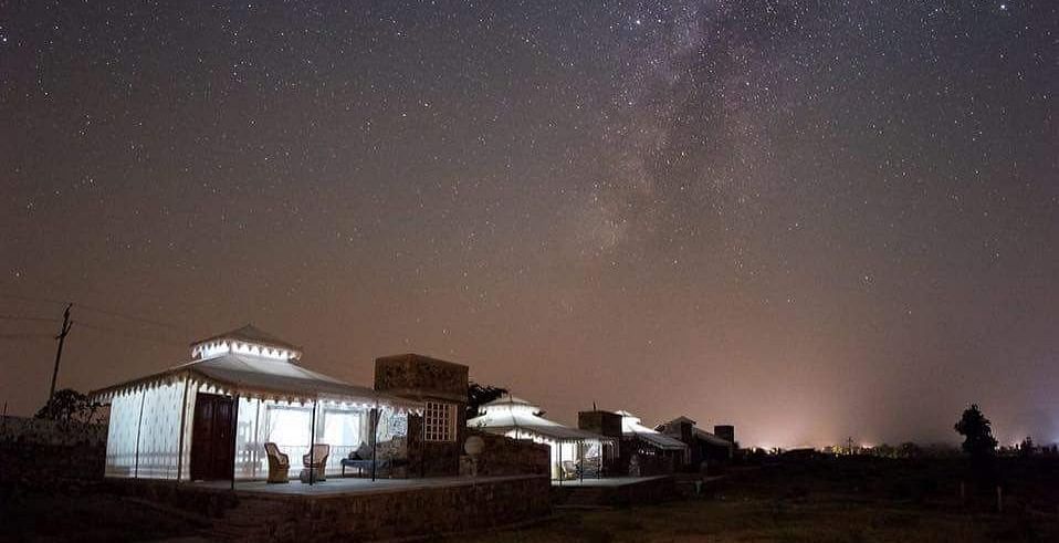 A facade image of the Utsav Camp Sariska which is brightly lit