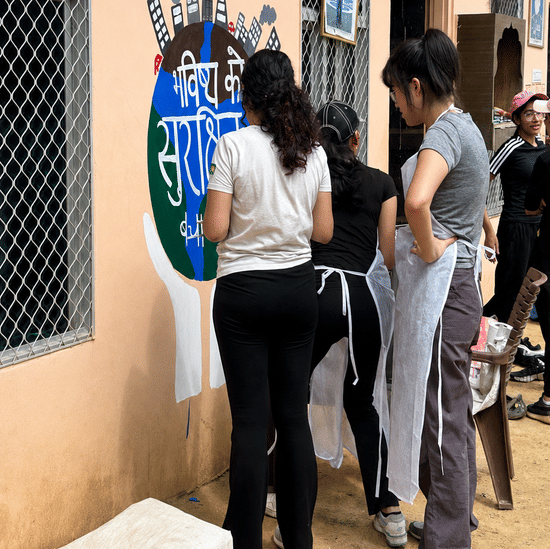 Volunteers painting a community mural-Umaid Palace Dausa-Resort Near Jaipur-Coprporate Offsite -Retreats-
