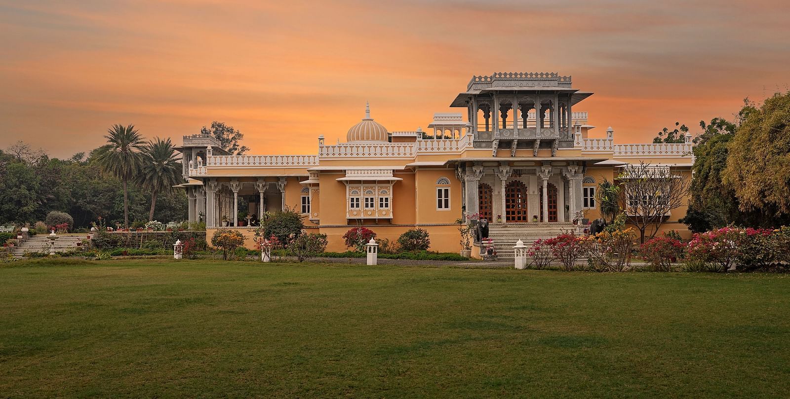 Facade image of dev shree, deogarh with a beautiful sunset sky with orange hues in the background