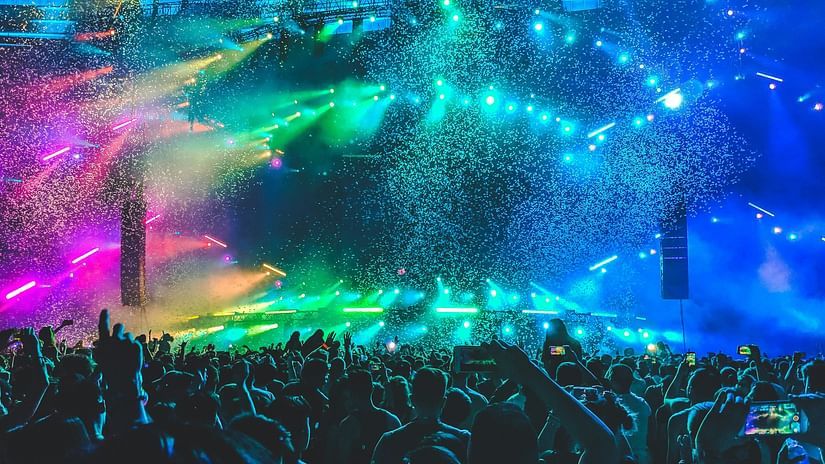 Concert night, pink, yellow,blue and green lights lighting up the stage