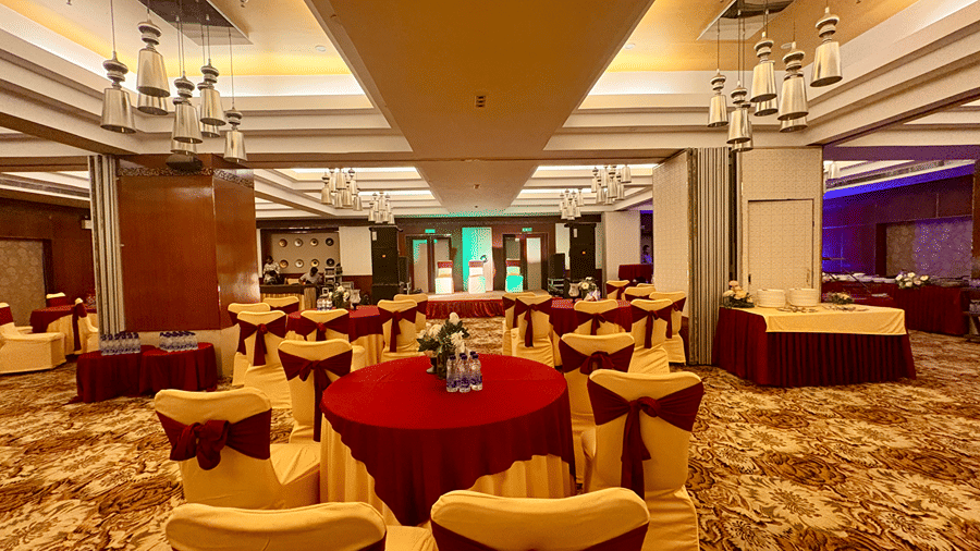 Back view of spacious banquet hall with lighting, central air-conditioner, and a stage - Senses Hotel