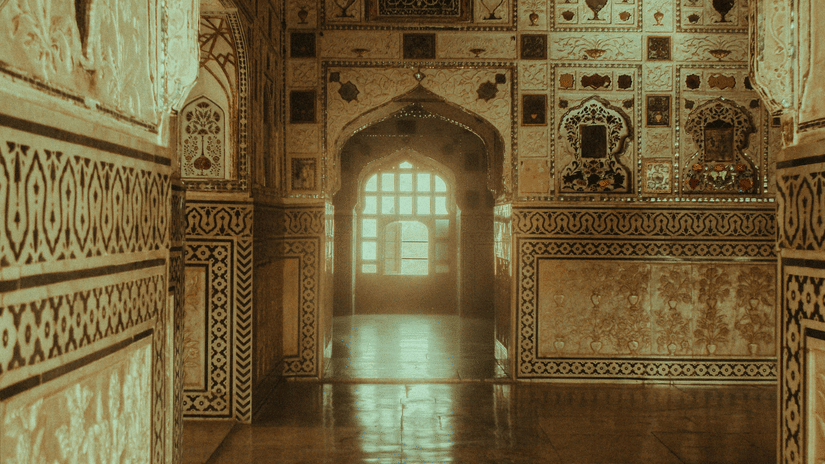 Intricate carvings and mirrored mosaics decorate the interior arches of a traditional Rajasthali palace.