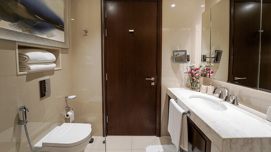 Address Fountain Views Residence Tower - the washroom equipped with a white marbled wash basin and towels kept under it