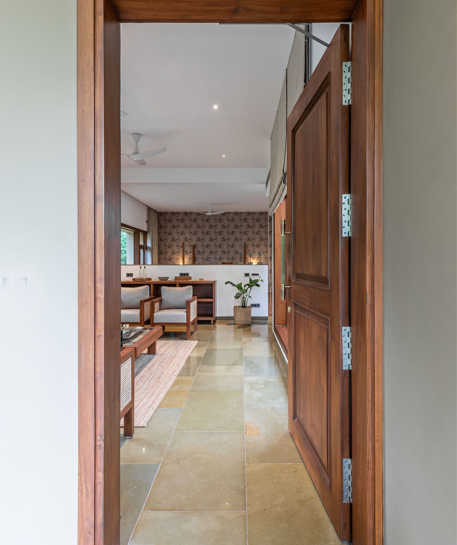 Open doorway leading to a hallway with a rug, view of a room, interior architecture - Shreyas Retreat