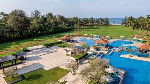 An aerial exterior shot of Kenilworth Resort & Spa, Goa featuring a vast swimming pool
