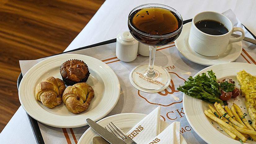 Room service breakfast tray with a variety of dishes and beverages