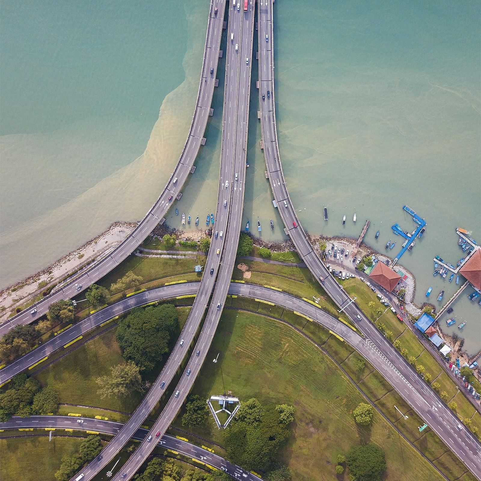 An overhead view of several bridges spanning across the water