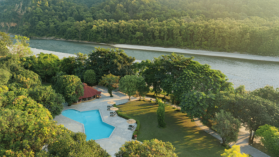 Aerial view of the swimming pool and landscaped grounds surrounded by lush greenery at The Riverview Retreat, Corbett.