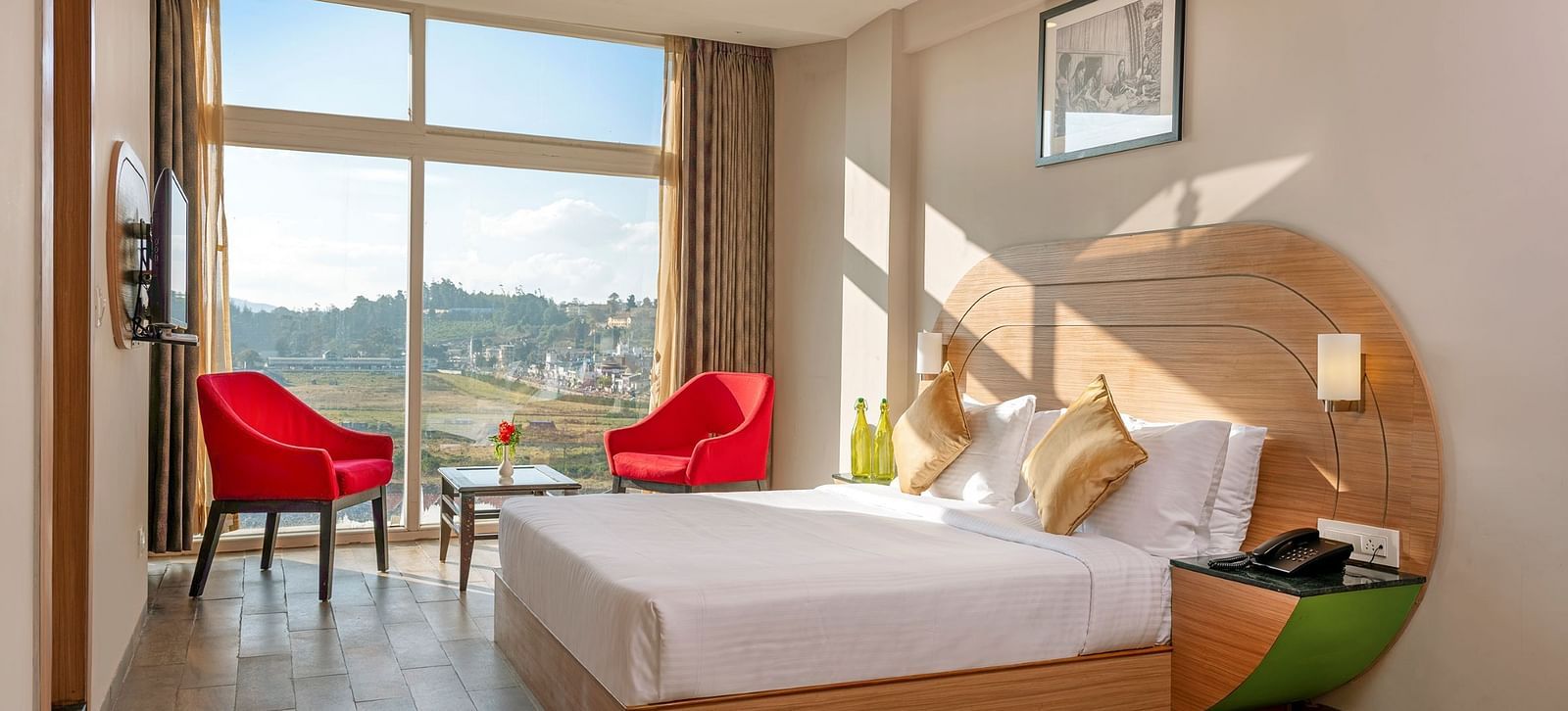 An image of a bedoom where natural light is seeping in through the glass window | Mango HIll Central, Ooty