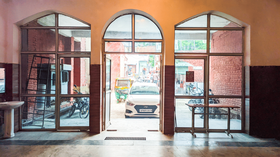 Entrance of a building with a car parked outside - Hotel Goverdhan, Agra