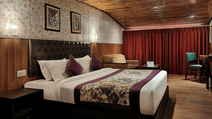 Elegant double bedroom with plush bedding and classic décor at Mount Thistle Boutique Hotel, Darjeeling.