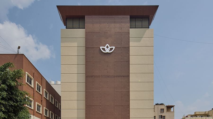 A front view of our hotel with modern architecture and greenery - Grand Continent, Brookefield
