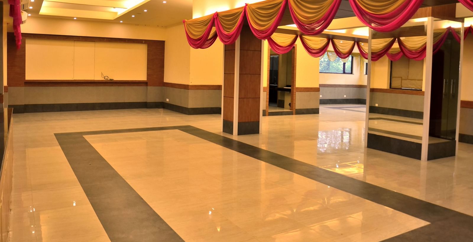 an expansive banquet hall well lit with warm lighting - Max Hotel, Jabalpur