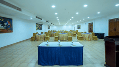 Orchid Hall set up with a head table and blue linen at Chariot Beach Resorts, ideal for conferences and formal business meetings.