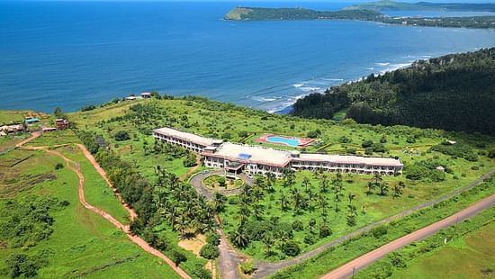 Kohinoor Samudra Beach Resort, situated amidst a verdant landscape of herbs and shrubs, enveloped by the serene ambience of the beach.