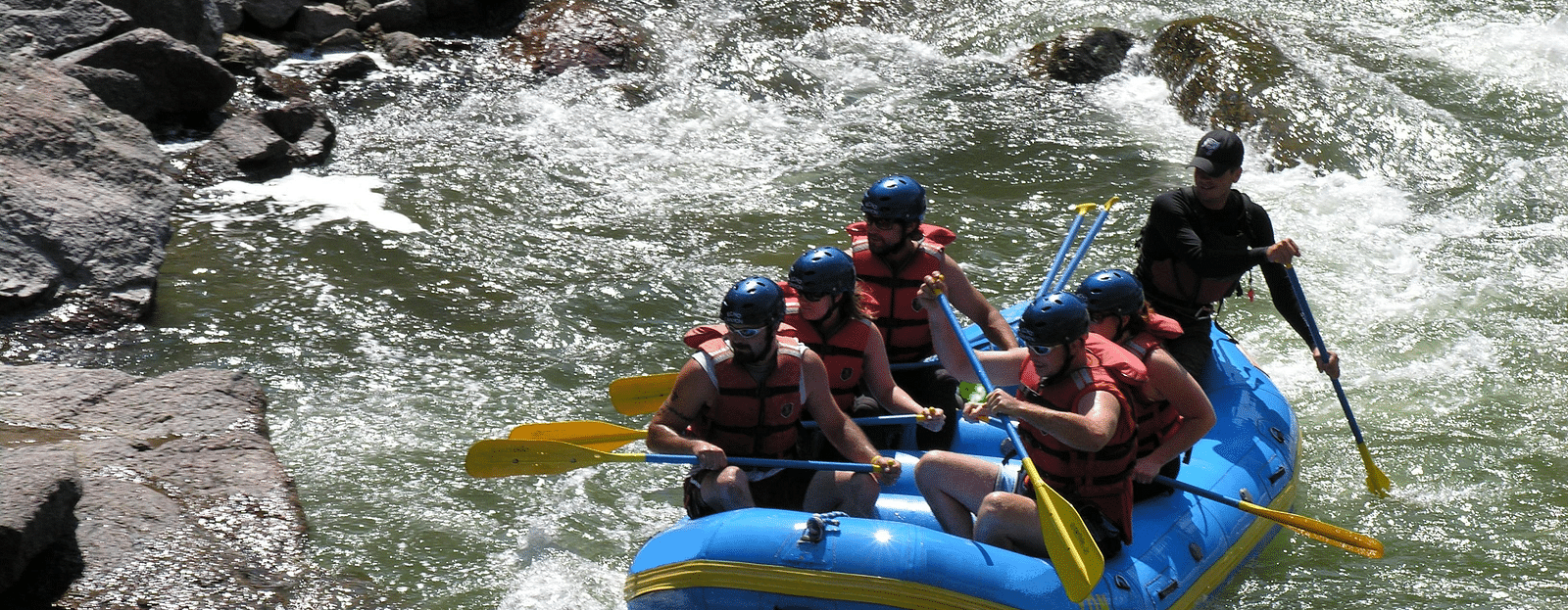 An image of a group of people rafting on a river