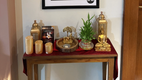 A serene spa entryway featuring a framed floral painting and a table with candles and decorative items - Praveg's Grand Eulogia, Ahmedabad