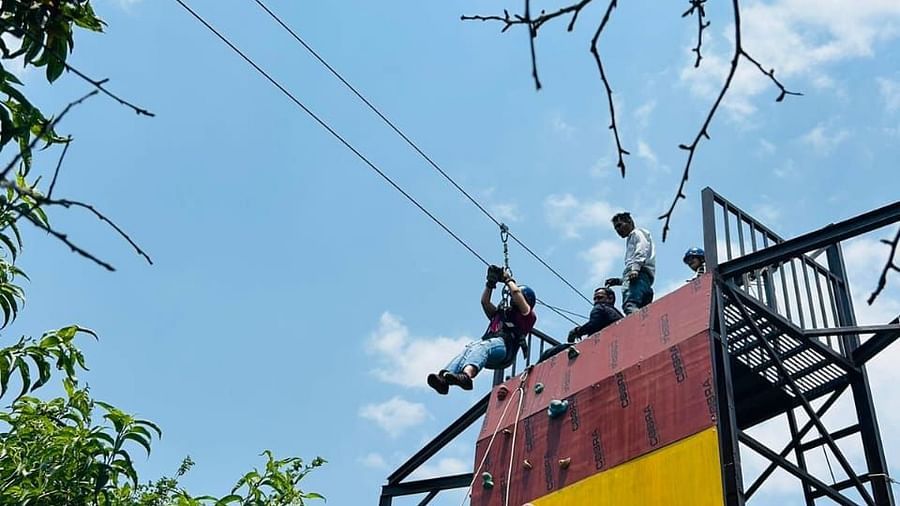 A closer look at the top section of the climbing wall, showcasing its height and the surrounding natural environment - Digantaa Resort in Mukteshwar