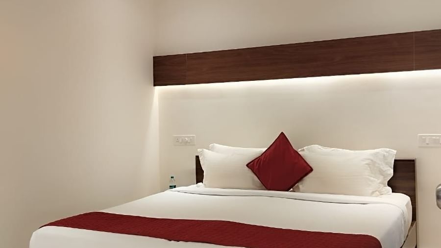 Modern bedroom with double bed, white walls, and minimal décor at Fantasy Golf Resort.