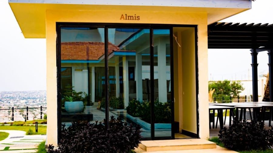 Small yellow building with glass doors and tiled walkway - Serene Sarovar Premiere Hargeisa